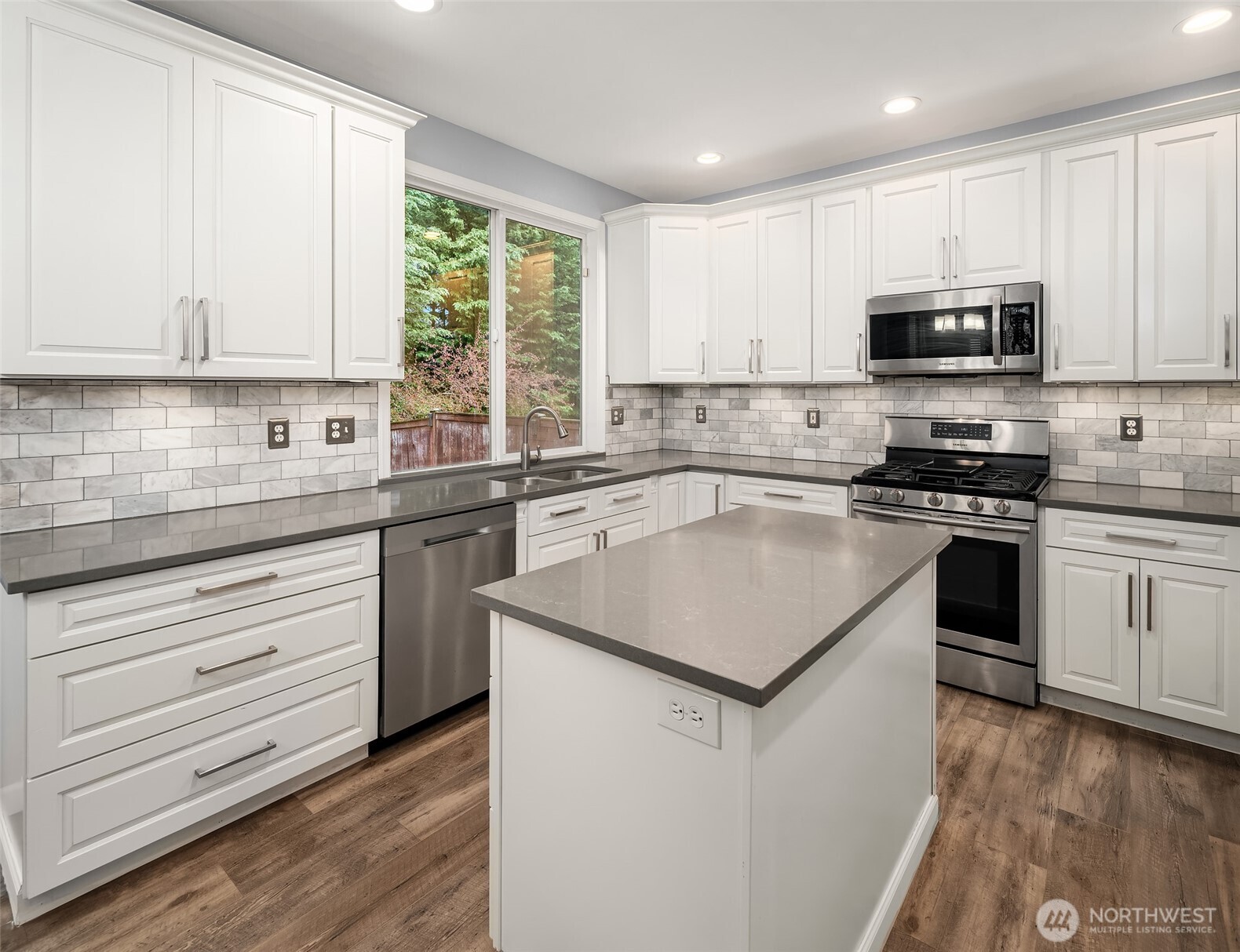 2009 62nd Loop Southeast Auburn, WA 98092 - Photo 5 of 24 a kitchen with stainless steel appliances a sink stove and cabinets