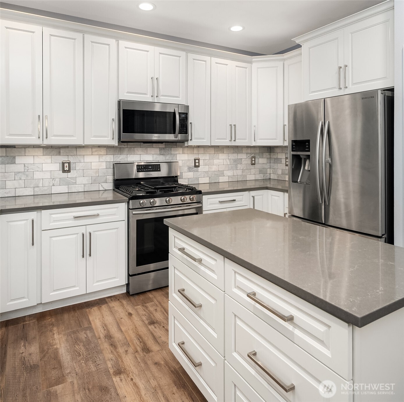 2009 62nd Loop Southeast Auburn, WA 98092 - Photo 6 of 24 a kitchen with granite countertop white cabinets and stainless steel appliances
