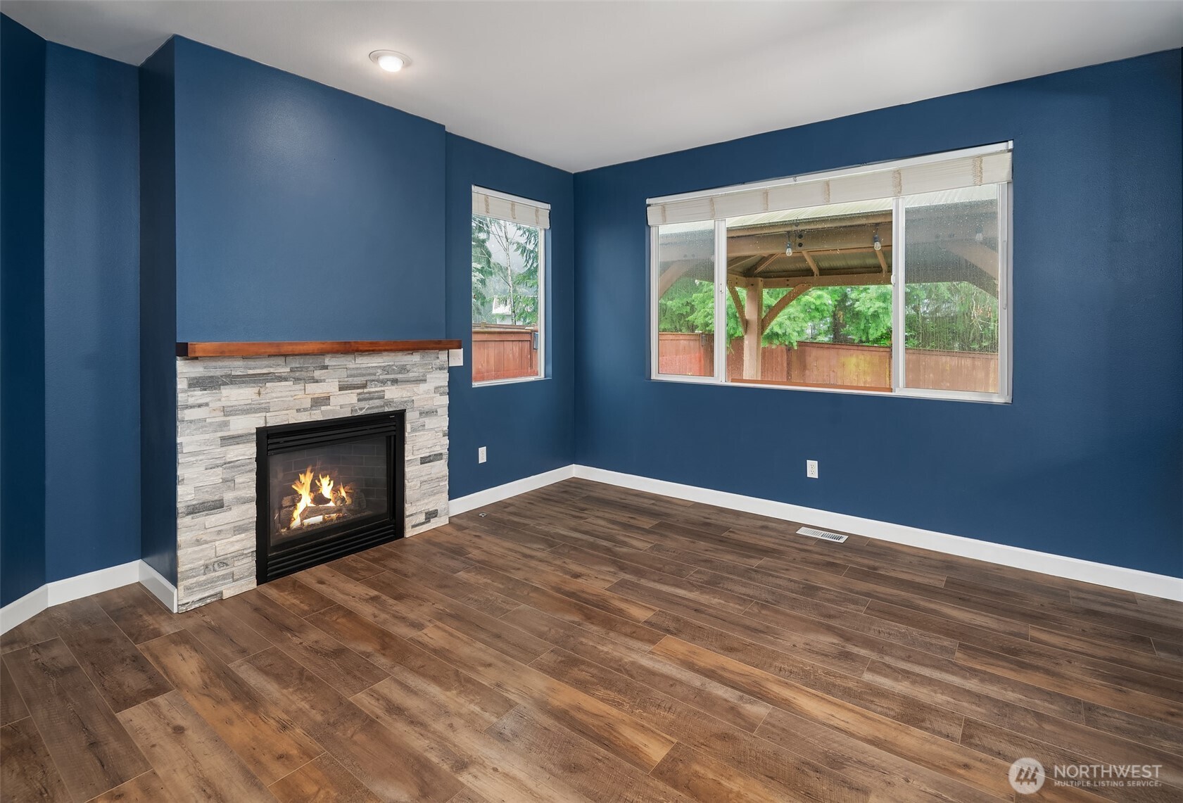 2009 62nd Loop Southeast Auburn, WA 98092 - Photo 8 of 24 a view of an empty room with a window and a fireplace