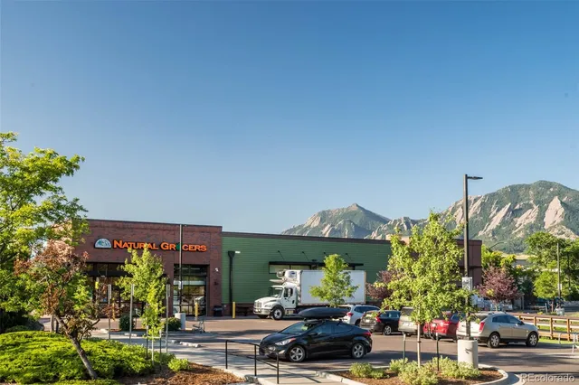an empty room with windows flat screen tv and couches