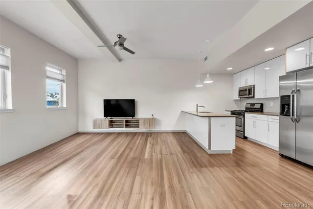 a view of kitchen with stainless steel appliances granite countertop refrigerator stove microwave and oven