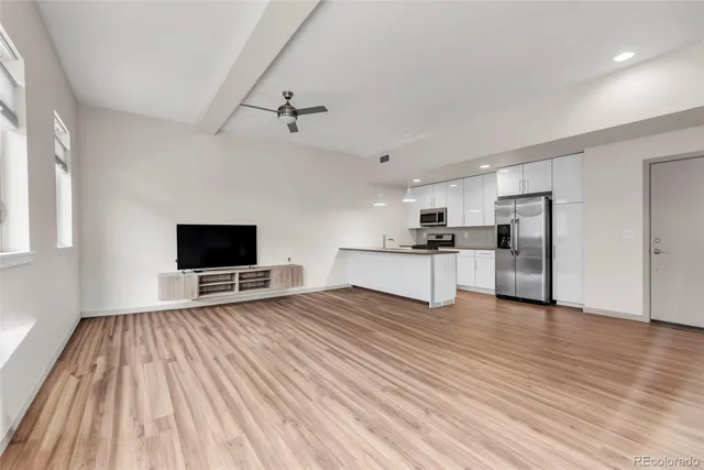 a kitchen with kitchen island a counter top space stainless steel appliances and cabinets