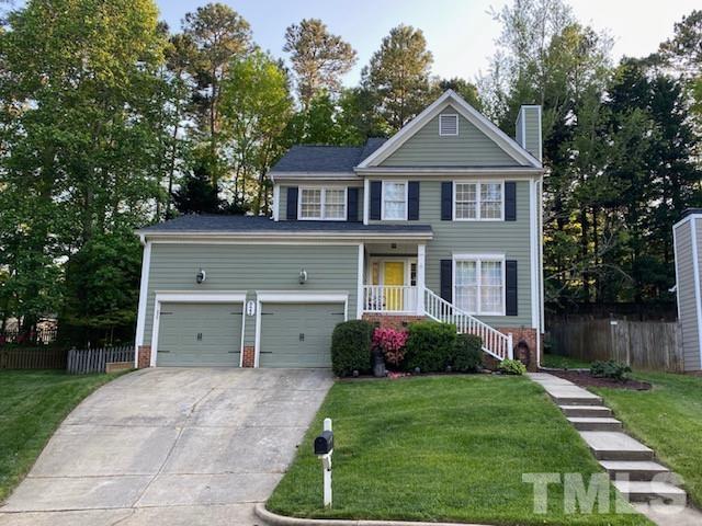 8644 Swarthmore Drive Raleigh, NC 27615 - Photo 1 of 26 a front view of a house with a yard and garage