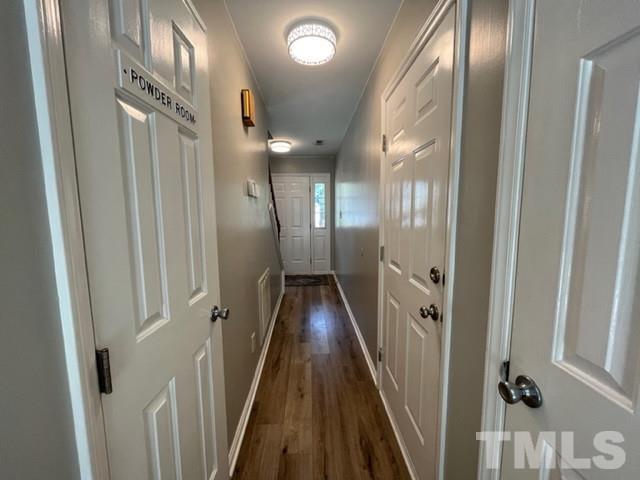 8644 Swarthmore Drive Raleigh, NC 27615 - Photo 16 of 26 a view of a hallway with wooden floor