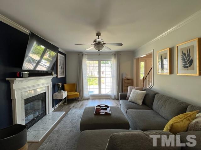 8644 Swarthmore Drive Raleigh, NC 27615 - Photo 6 of 26 a living room with furniture a flat screen tv and a fireplace