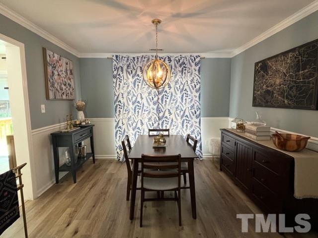 8644 Swarthmore Drive Raleigh, NC 27615 - Photo 7 of 26 a view of a dining room with furniture window and wooden floor