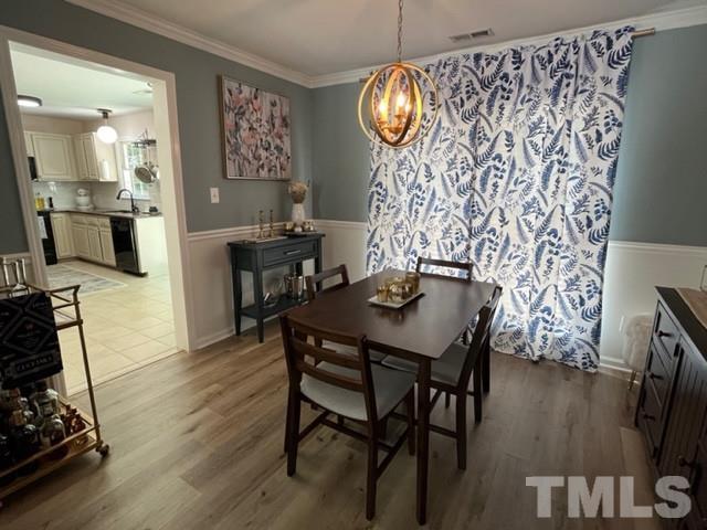 8644 Swarthmore Drive Raleigh, NC 27615 - Photo 8 of 26 a view of a dining room with furniture and wooden floor