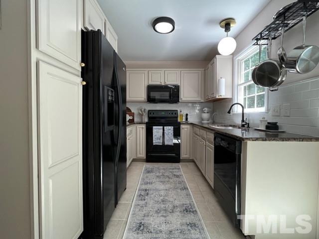 8644 Swarthmore Drive Raleigh, NC 27615 - Photo 9 of 26 a kitchen with a sink and a stove top oven