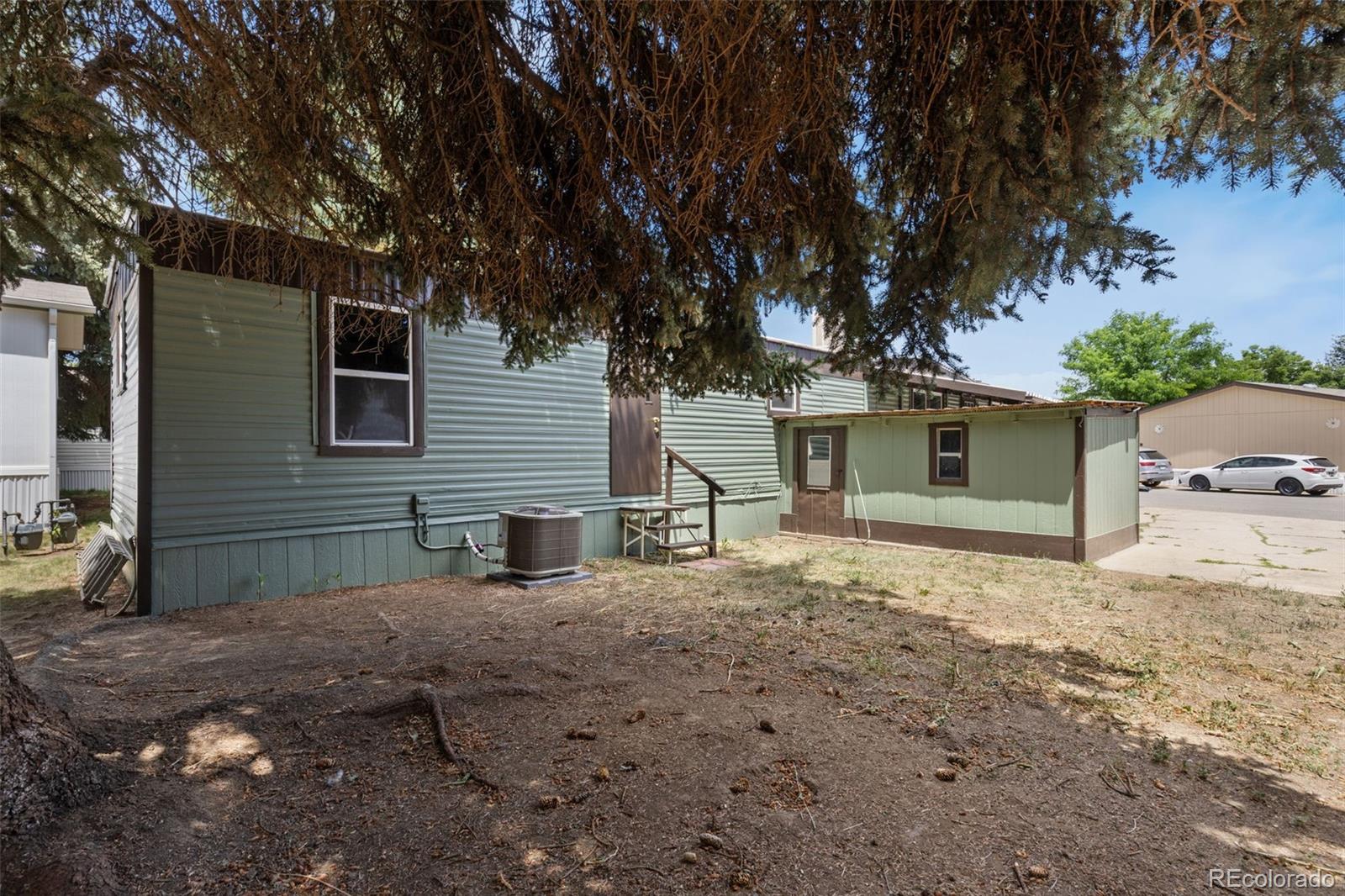 230 North 2nd Street Berthoud, CO 80513 - Photo 2 of 15 a front view of a house with a yard and garage