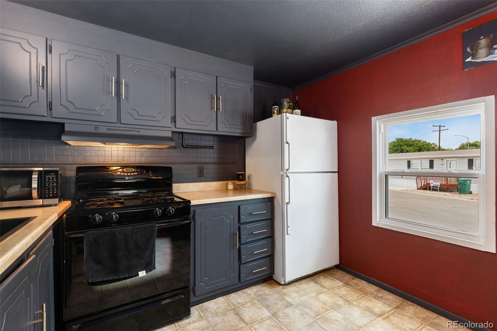 230 North 2nd Street Berthoud, CO 80513 - Photo 9 of 15 a kitchen with a stove and a refrigerator