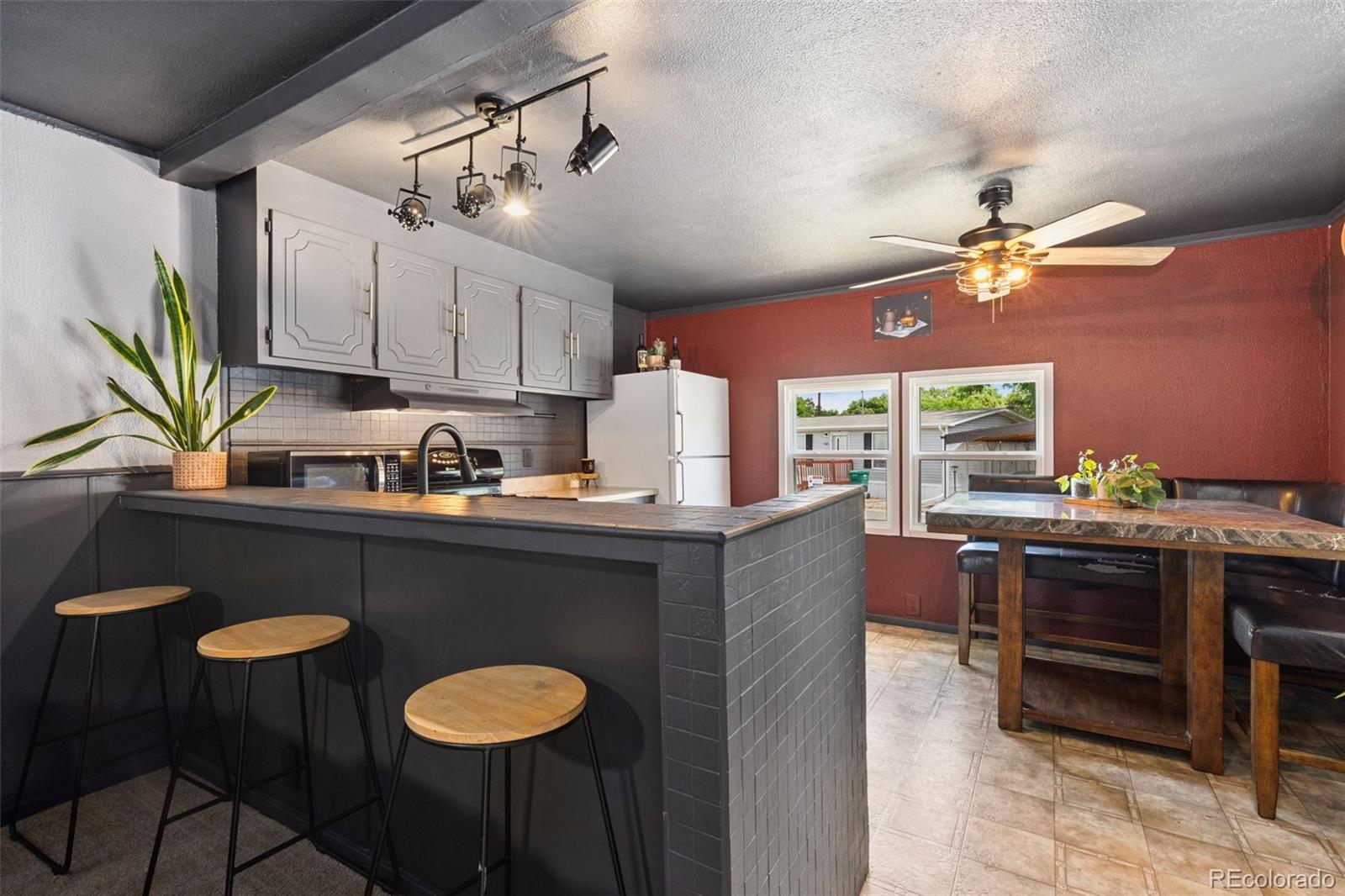 230 North 2nd Street Berthoud, CO 80513 - Photo 10 of 15 a kitchen with stainless steel appliances granite countertop a stove a sink dishwasher and a table with chairs