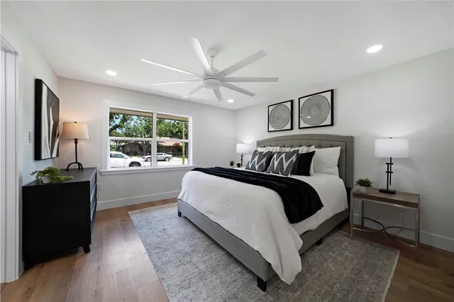 a bedroom with a bed and wooden floor