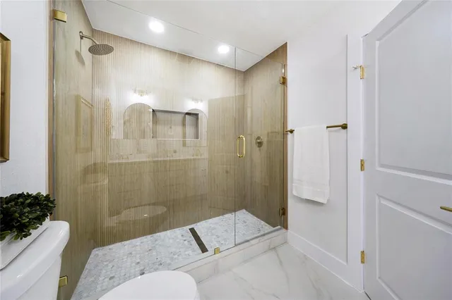 a bathroom with a toilet a sink and shower