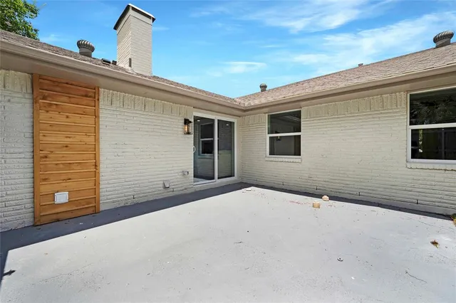 a view of a house with wooden fence