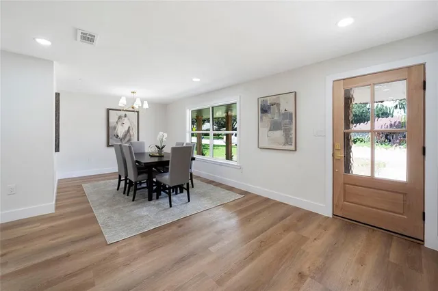 a view of a livingroom with furniture window and wooden floor