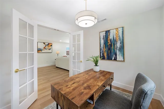 a living room with furniture and wooden floor