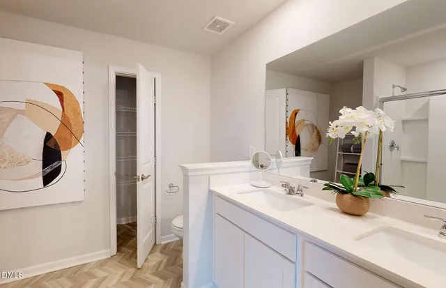 a bathroom with a sink a vanity and a mirror