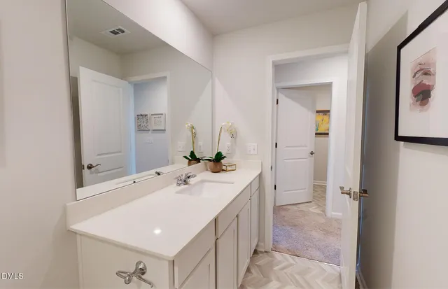 a bathroom with a sink a mirror and a vanity
