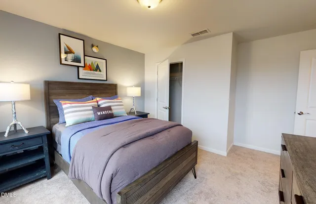 a bedroom with a bed and lamp