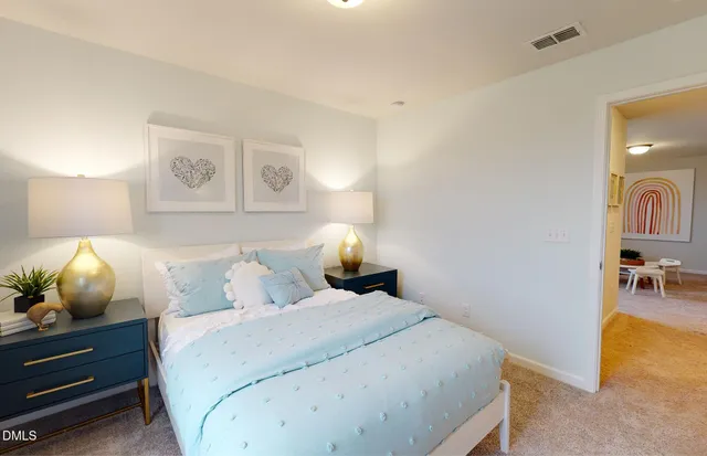 a bedroom with a bed and lamp