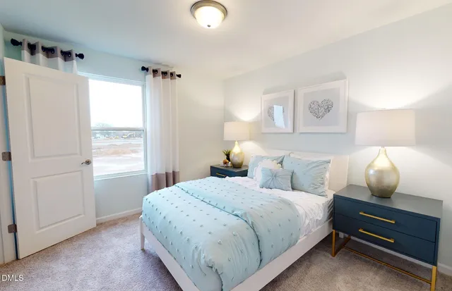 a bedroom with a bed and a lamp