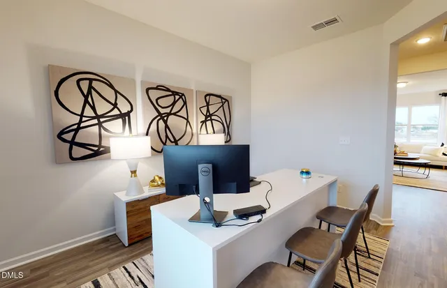 a work room with furniture and wooden floor