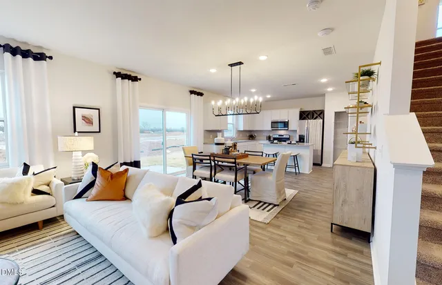 a living room with furniture and a chandelier