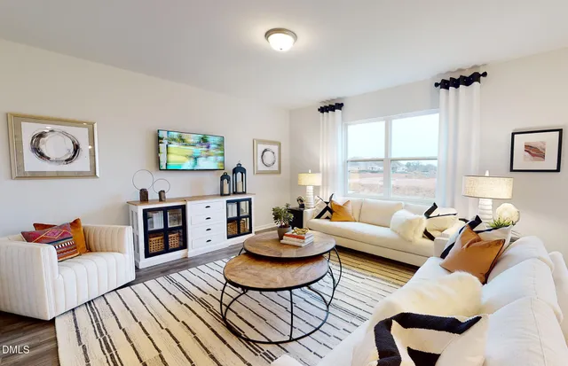 a living room with fireplace furniture and a large window
