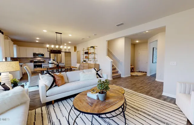 a living room with furniture kitchen view and a table