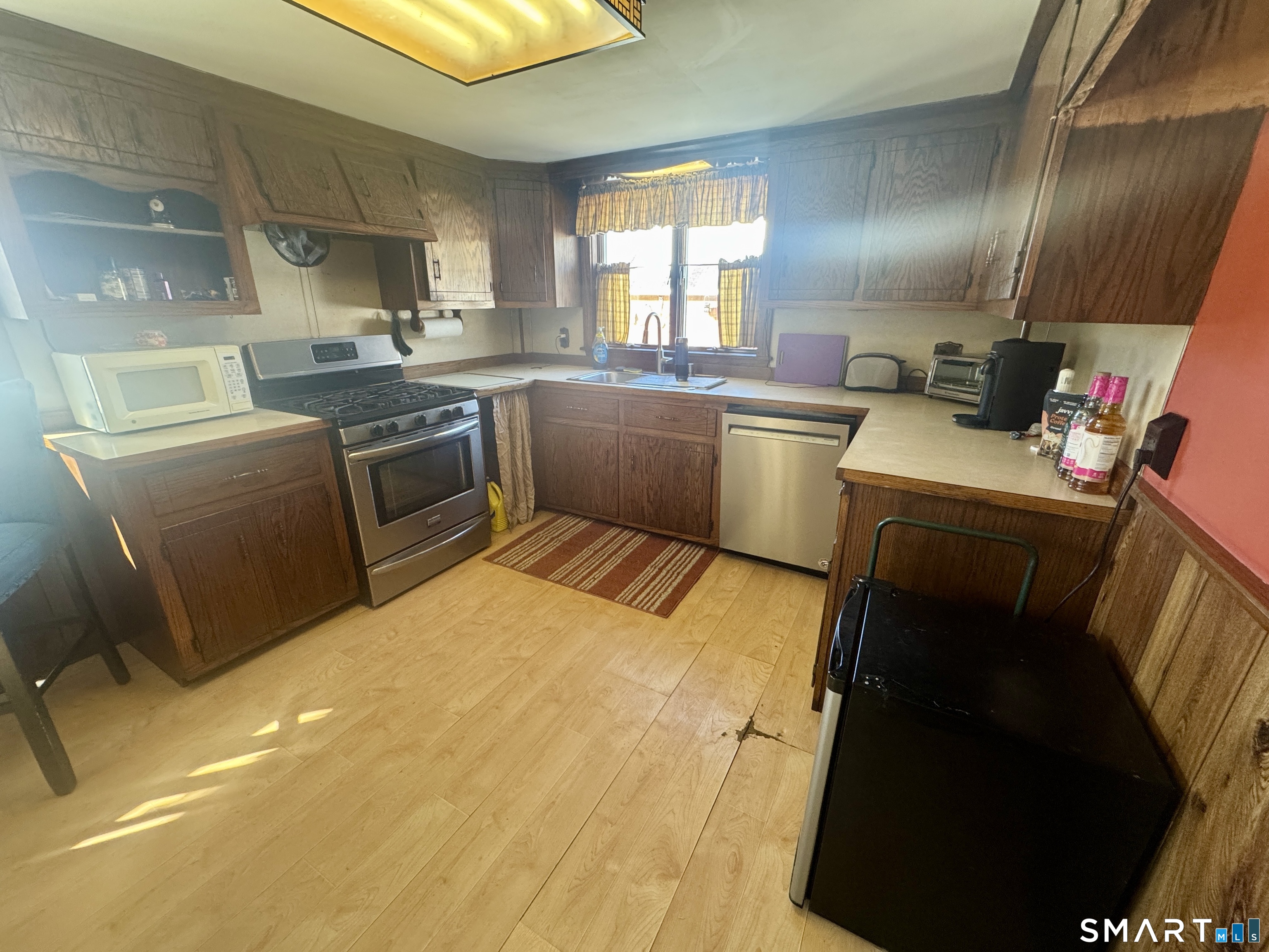 a kitchen with a stove sink and cabinets