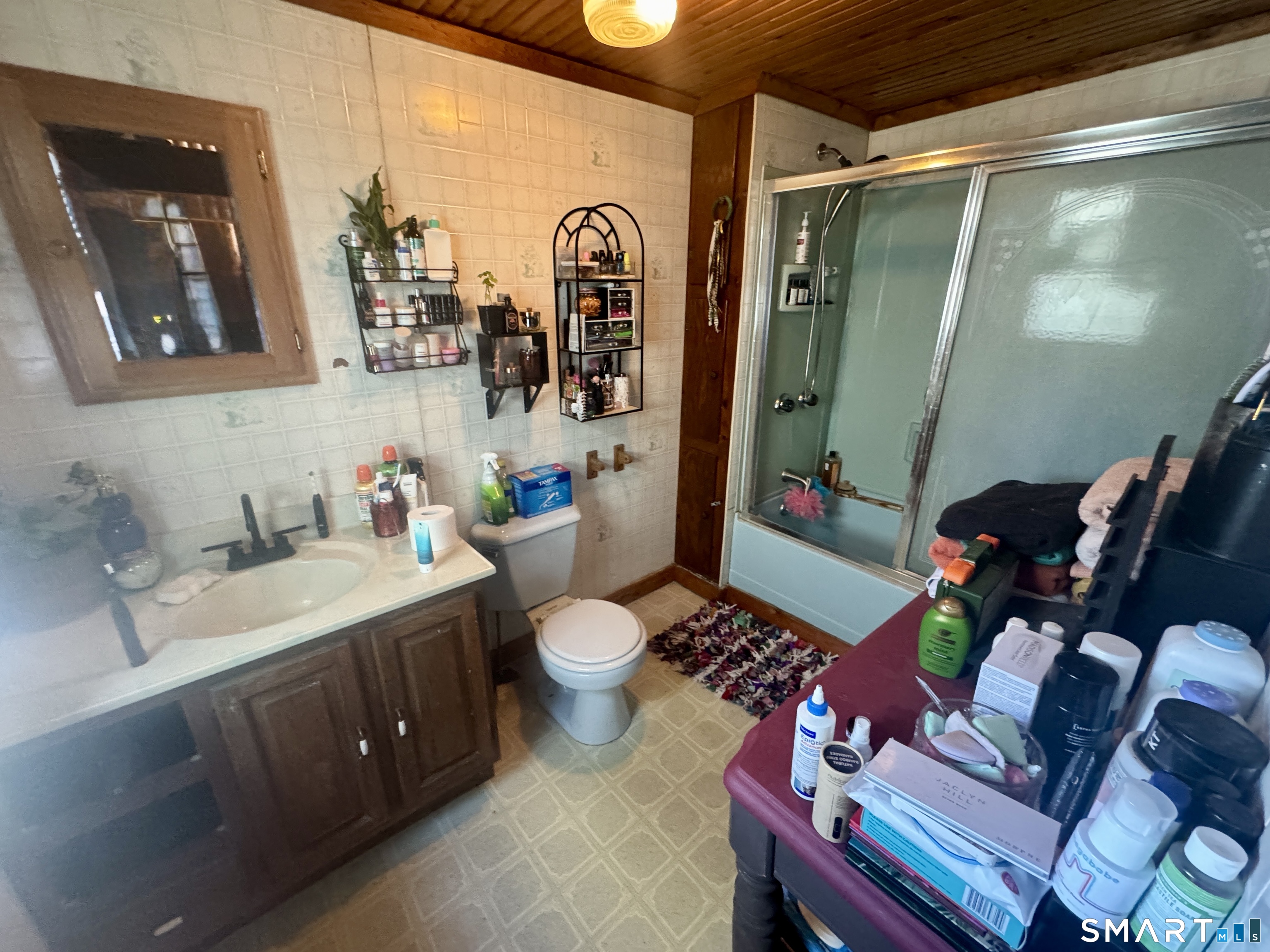 279 Putnam Pike Killingly, CT 06241 - Photo 27 of 39 a bathroom with a sink mirror vanity and toilet
