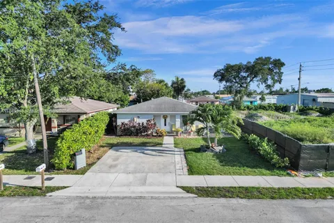 a view of a garden with a bench under an umbrella