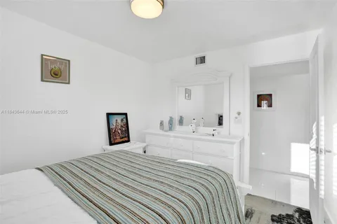 a bedroom with bed and window