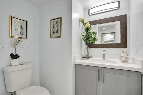 a bathroom with a toilet a sink and mirror