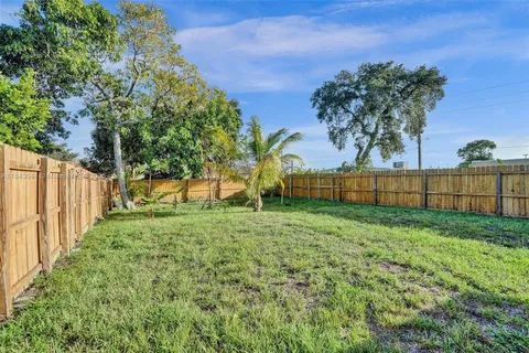 a view of a patio with a table and chairs under an umbrella