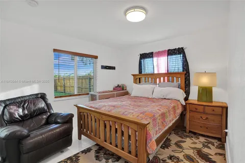 a bedroom with a bed couch and a window