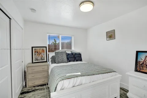 a bedroom with a bed and a lamp