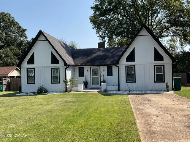 a front view of house with yard outdoor seating and barbeque oven