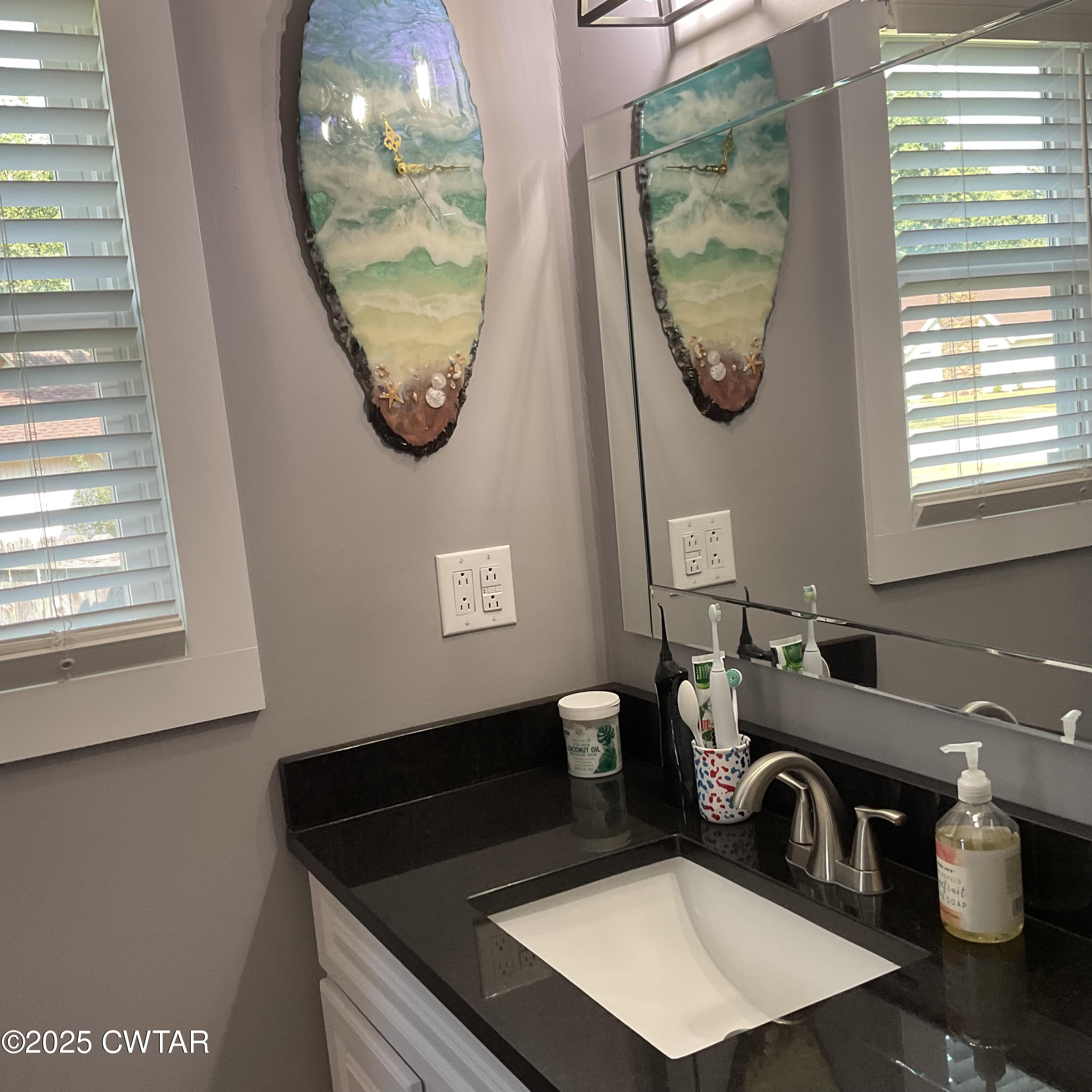28 Beaver Cove Jackson, TN 38305 - Photo 12 of 18 a bathroom with a granite countertop sink and a mirror