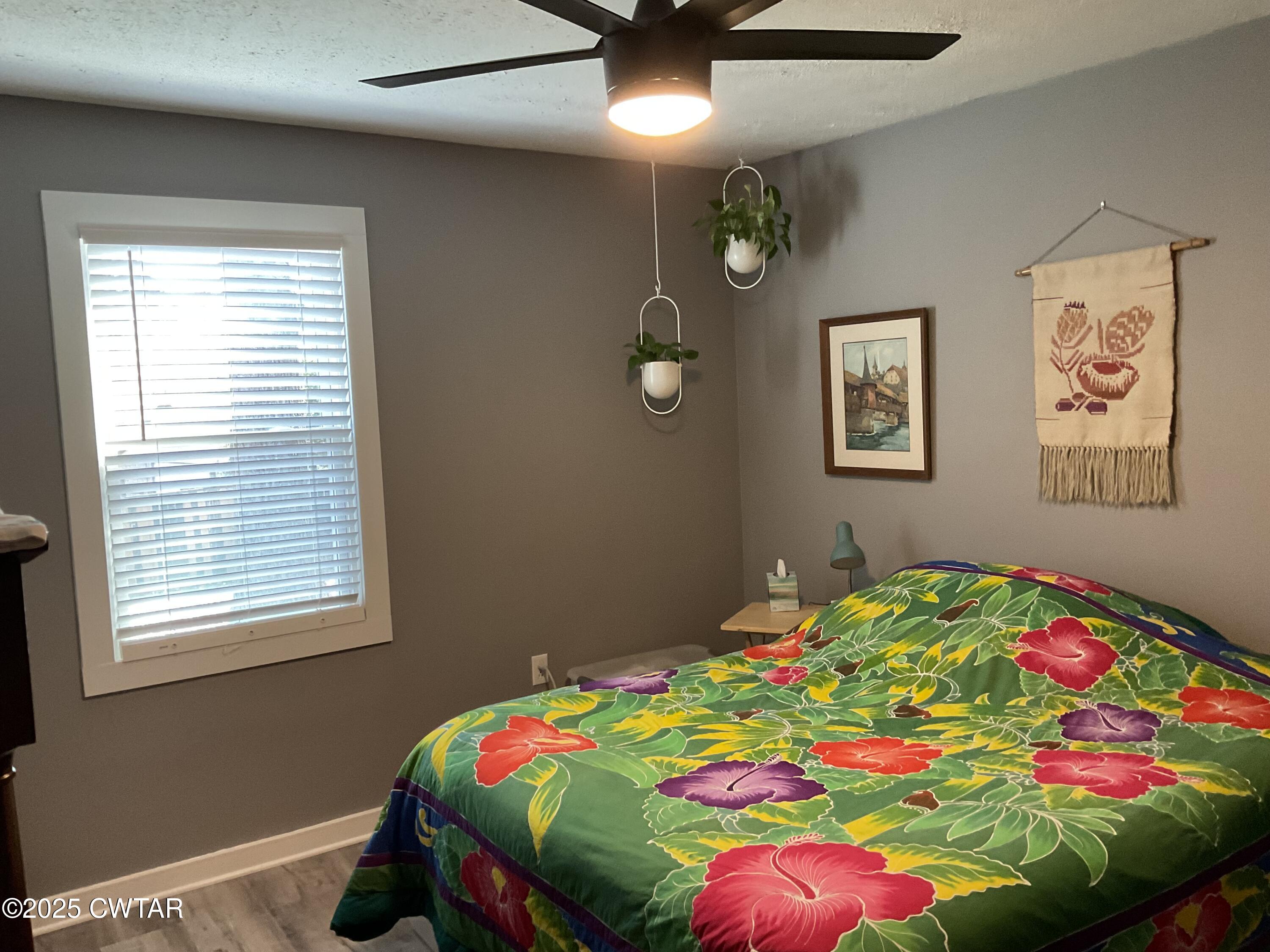 28 Beaver Cove Jackson, TN 38305 - Photo 15 of 18 a bedroom with a bed and a chandelier