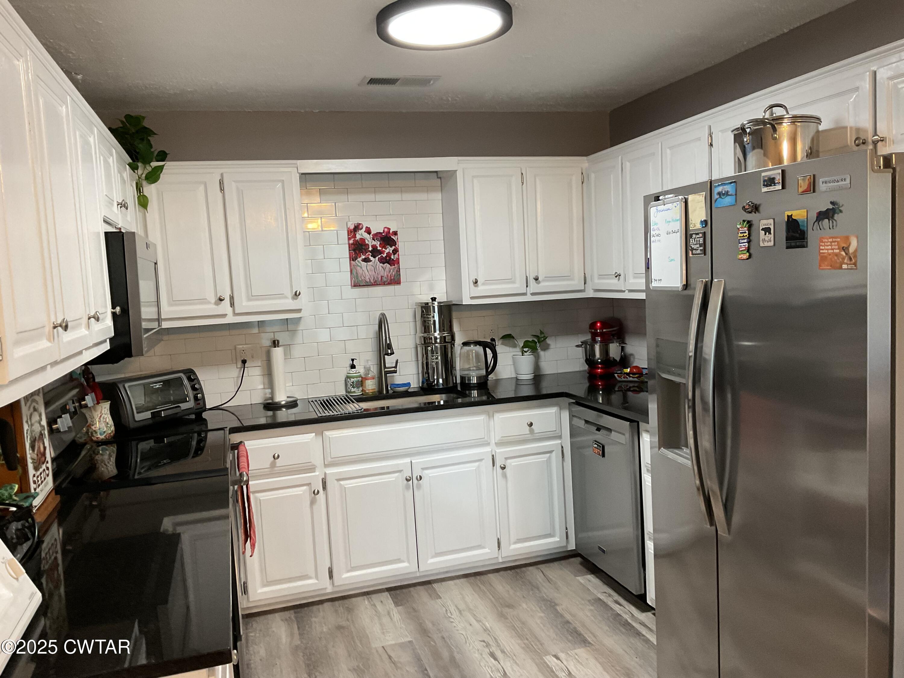 28 Beaver Cove Jackson, TN 38305 - Photo 6 of 18 a kitchen with a sink stainless steel appliances and cabinets