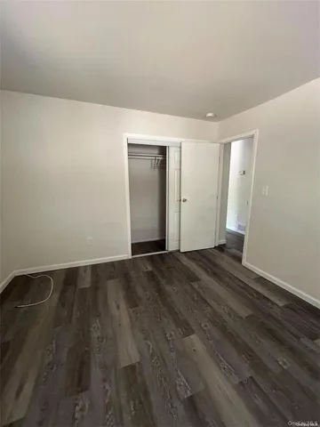 a view of an empty room and wooden floor