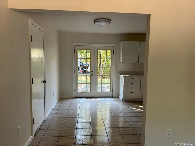a view of a hallway with windows and brick walls
