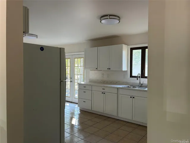 a spacious bathroom with a granite countertop sink a mirror and a