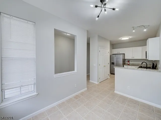 a view of kitchen with stainless steel appliances refrigerator oven and cabinets