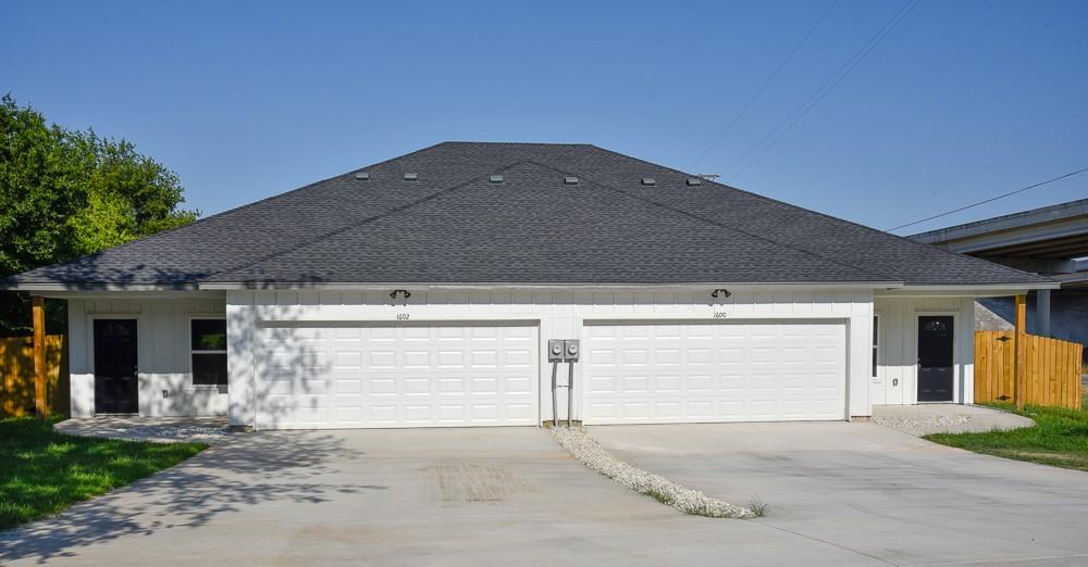 1602 North Mcdonald Avenue Decatur, TX 76234 - Photo 1 of 13 a front view of a house with a garage