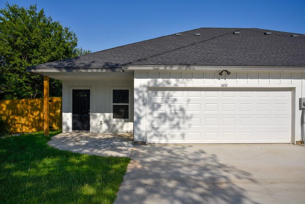 1602 North Mcdonald Avenue Decatur, TX 76234 - Photo 2 of 13 a front view of a house with garden
