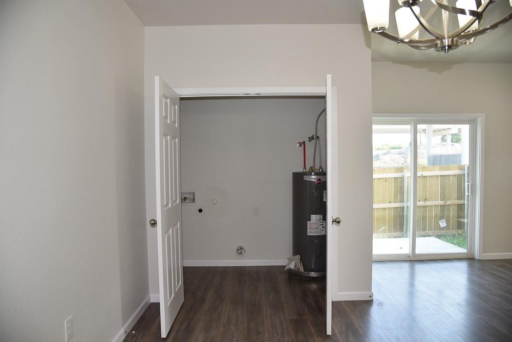 1602 North Mcdonald Avenue Decatur, TX 76234 - Photo 4 of 13 an empty room with wooden floor and a window