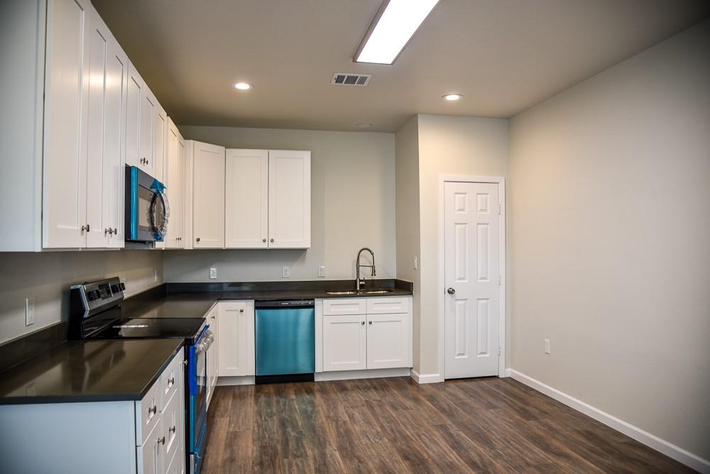 1602 North Mcdonald Avenue Decatur, TX 76234 - Photo 5 of 13 a kitchen with granite countertop a sink a stove and cabinets