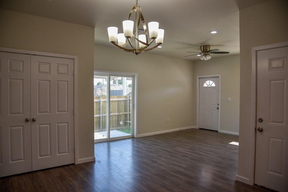 1602 North Mcdonald Avenue Decatur, TX 76234 - Photo 6 of 13 wooden floor in an empty room with a window